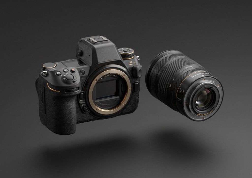 Two professional camera lenses arranged on a dark studio background